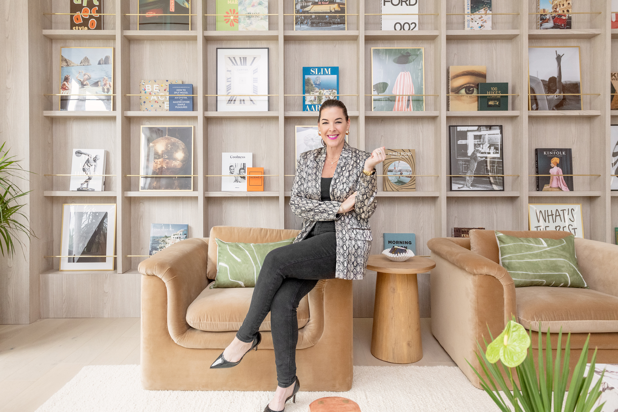 Ann Lopez seated in a designed library lounge with velvet chairs
