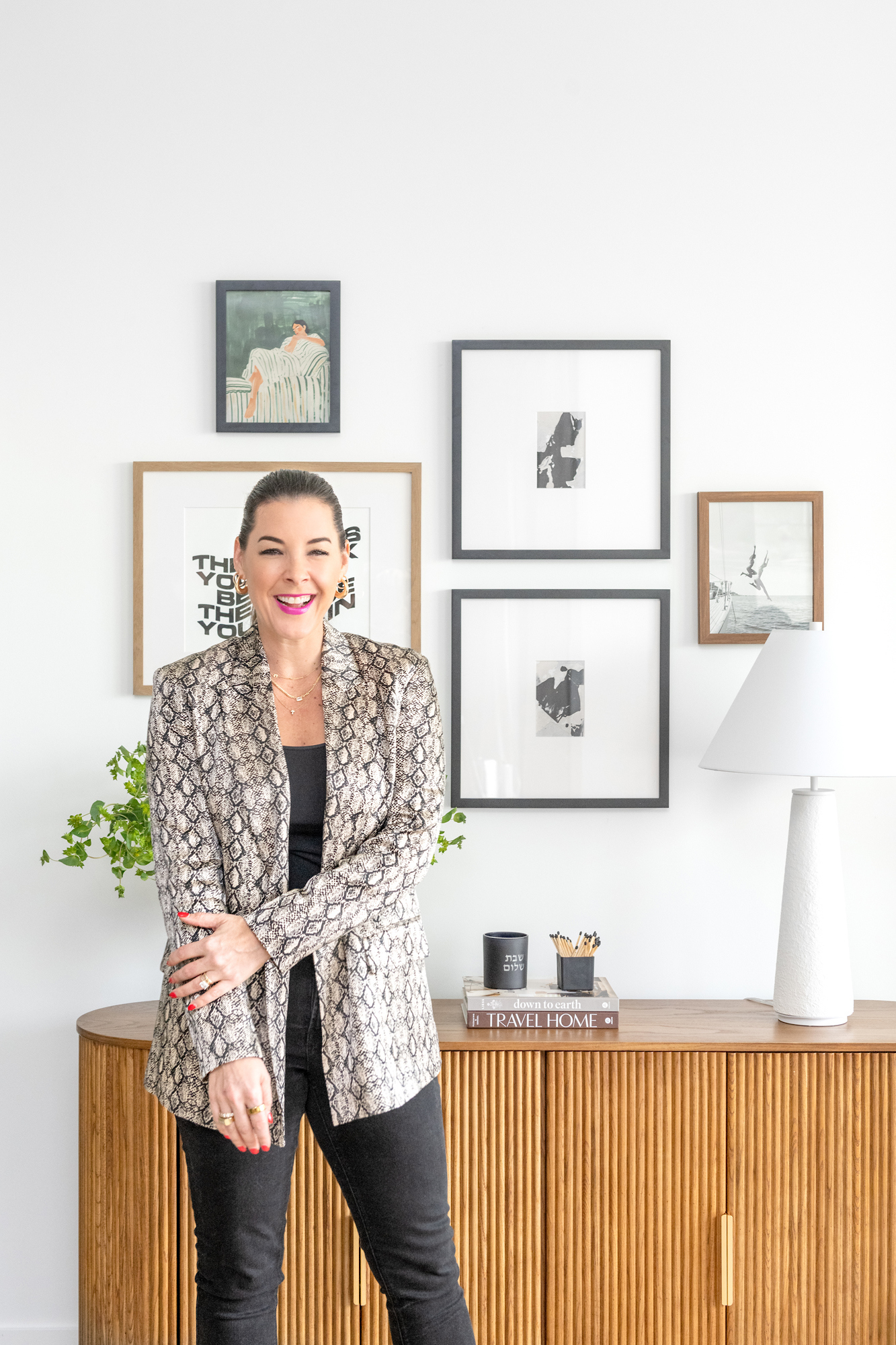 Ann Lopez, founder of Studio 790, standing beside a fluted oak console