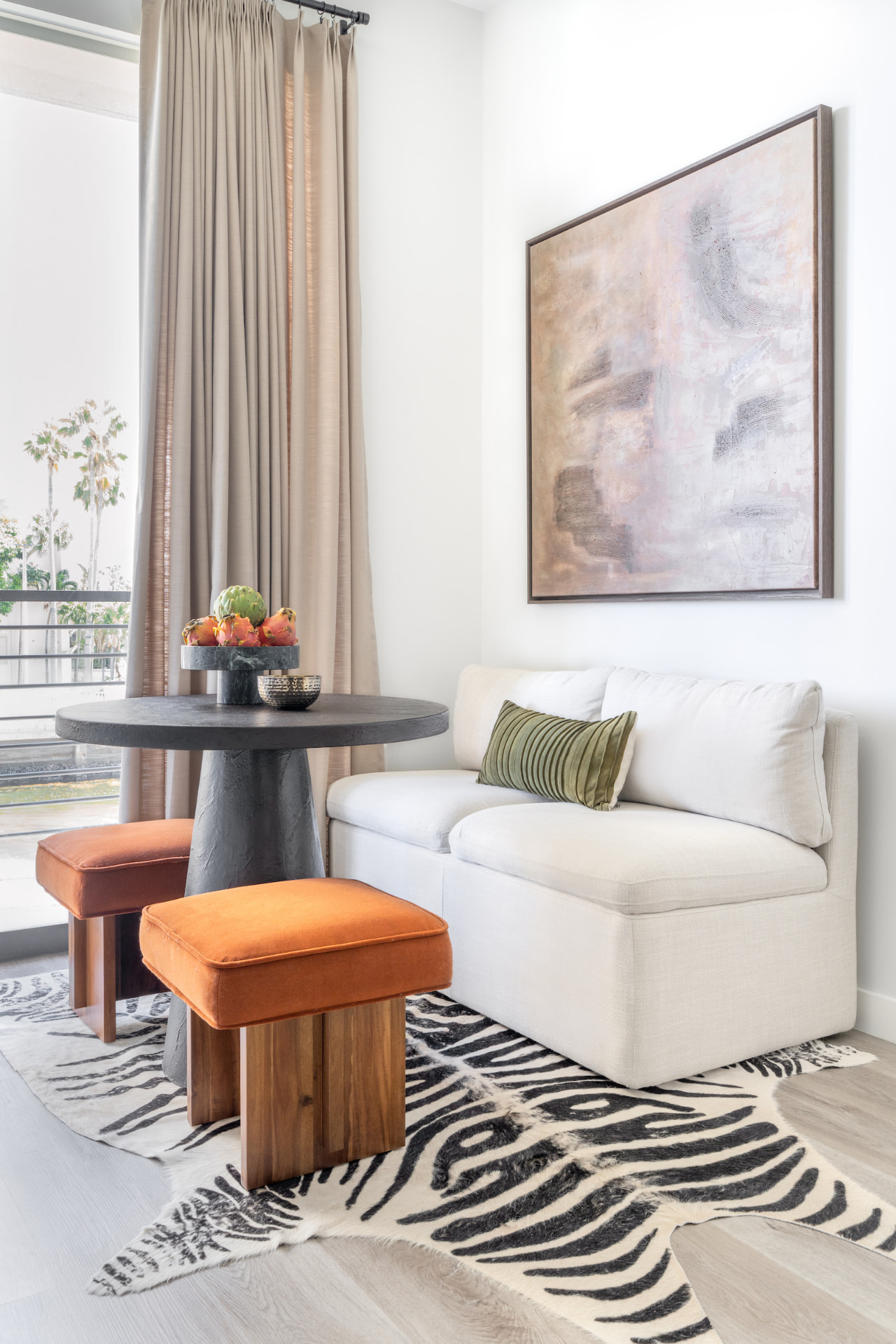 Seating vignette with orange stools and marble table
