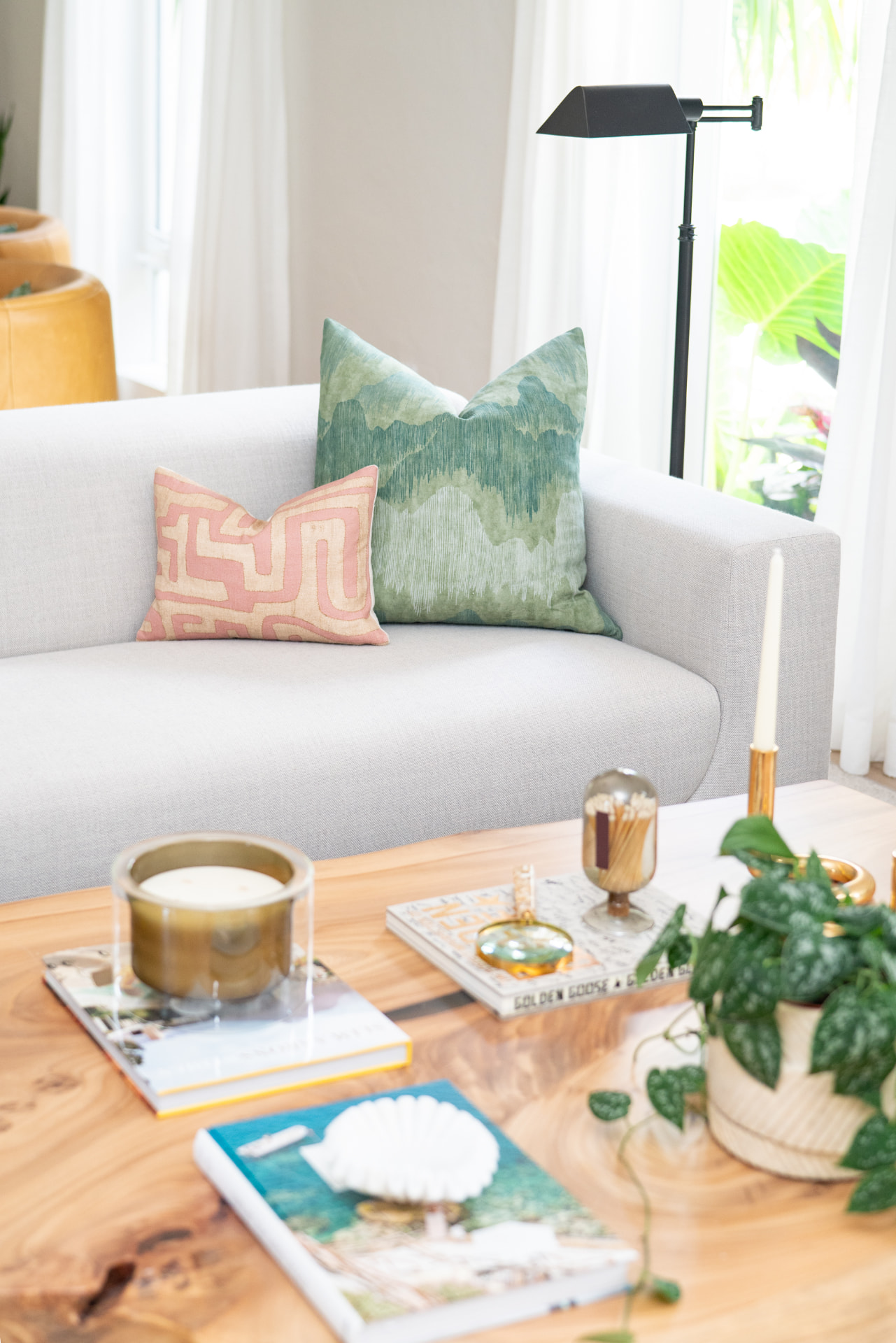 Styled coffee table detail with candle and trailing plant